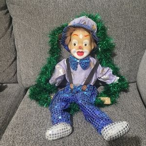 Porcelain clown on swing.